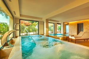 a large swimming pool with a slide in a house at Hotel Serawa Moraira in Moraira