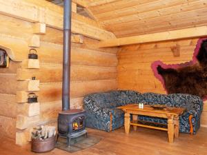 a living room with a couch and a wood stove at 8 person holiday home in Ebeltoft in Ebeltoft