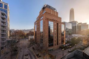 a tall brick building in the middle of a city at Four Points by Sheraton Santiago in Santiago