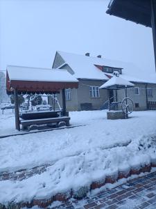 a bus stop covered in snow in a yard at Sielankowy Domek in Istebna