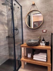 a bathroom with a sink and a mirror at Etna Chalet Nicolosi in Nicolosi