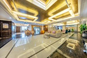 a lobby with couches and tables in a building at ST Hotel Wattay Airport in Vientiane