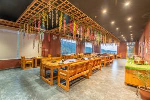 a dining room with wooden tables and colorful decorations at Hotel Moonglade By Royal Stays Dalhousie in Dalhousie