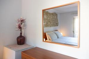 a bedroom with a bed and a mirror on the wall at Casa Vacanza "Marinella" in Sulmona +21 photos