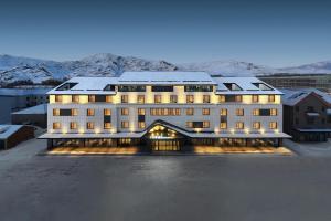 a large building with snow on top of it at Ace Hotel Keketuohai in Temeke