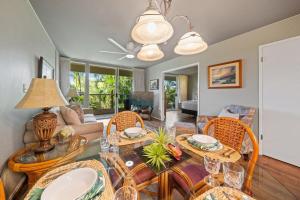 a living room with a dining table and chairs at Maui Banyan H207 · MB H207 Maui Escape Near Beach, Pool & Hot Tu in Kihei