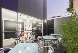 a restaurant with tables and chairs in a building at YU! Smarthotels in Guayaquil