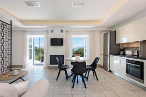 a kitchen and living room with a table and chairs at Thea Estate in Kelliá