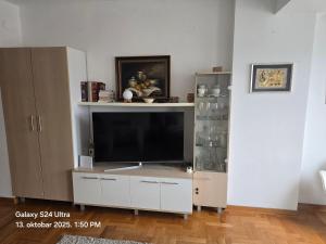 a living room with a large entertainment center with a flat screen tv at Apartman 13 Valjevo in Valjevo