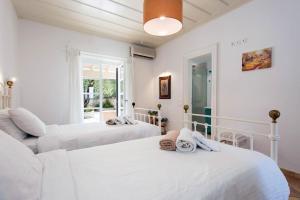 a bedroom with two beds and a window at Thea Estate in Kelliá