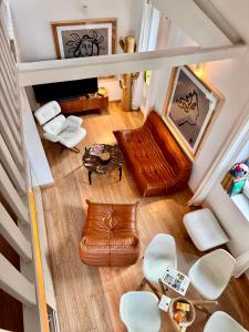 an overhead view of a living room with a couch and chairs at La Petite Adresse du 10Honfleur in Honfleur