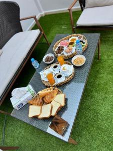 a breakfast table with food and bread and drinks at Residance touristique marcadal by mon rêve in Fort de lʼEau