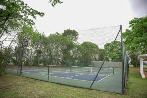a tennis court with two tennis courts at Umdoni Farm Lodge in Mahlanya
