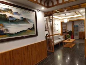 a living room with a large painting on the wall at Yesuhanshe Homestay in Zhangjiajie