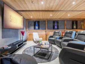 a waiting room with leather reclining chairs and a screen at Chalet Familial Spacieux Le Spencer Grand Luxe Châtel in Châtel +32 photos