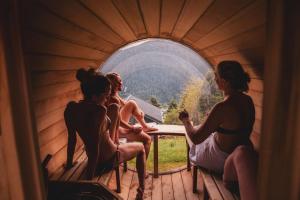 three women sitting in a tent looking out a window at Chalet Familial Spacieux Le Spencer Grand Luxe Châtel in Châtel