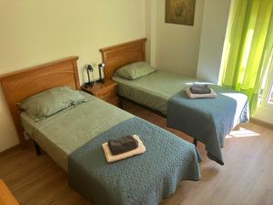 a bedroom with two beds with towels on them at Villa garden and sea in Alicante +22 photos