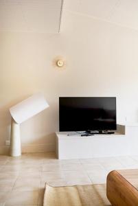 a living room with a large flat screen tv at Docatange in Boisgasson