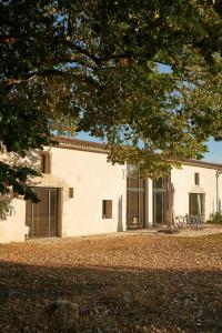 a white building with sliding glass doors on it at Restored Farm Estate Near Atlantic Coast France in La-Gripperie-Saint-Symphorien +32 photos
