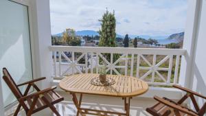 a table and chairs on a balcony with a view at Perdika Residences in Perdika +86 photos