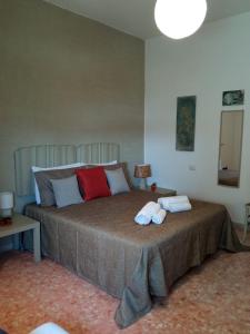 a bedroom with a large bed with two towels on it at MyHouse in Olbia
