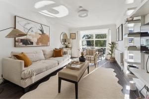 a living room with a couch and a table at Elegant 1-Bed Flat with Parking & Long Walk Views in Windsor