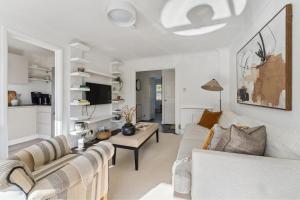 a living room with a couch and a table at Elegant 1-Bed Flat with Parking & Long Walk Views in Windsor