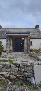 a stone house with a blue door and a stone wall at 4Guest-2Bedroom-Wifi-Parking in Deerpark