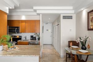 a kitchen with a table and a counter top at Lahaina Shores 607 · LS 607 Beachfront Remodeled Studio Stunnin in Lahaina
