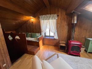 a living room with a bed and a window at Renovated Mountain View Appartment in Auronzo di Cadore