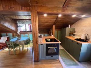 a kitchen with a stove and a table in a room at Renovated Mountain View Appartment in Auronzo di Cadore +8 photos