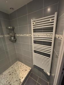 a bathroom with a shower with a shower head at Une escapade à l'estacade in Deauville