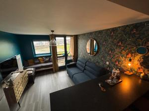 a living room with a couch and a table at Une escapade à l'estacade in Deauville