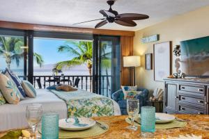 a bedroom with a bed and a view of the ocean at Lahaina Shores 413 · LS 413 Breathtaking Beachfront Remodeled St in Wainee
