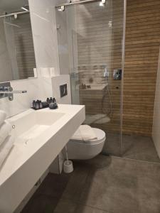 ein Badezimmer mit Waschbecken, Toilette und Dusche in der Unterkunft H7 TLV in Tel Aviv + 16 Fotos