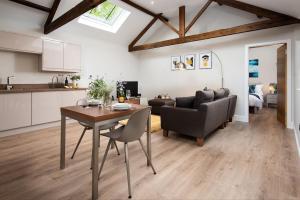 a kitchen and living room with a table and a couch at The Smithy at West Lyham in Chatton +7 photos