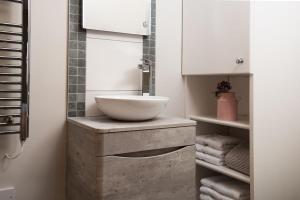 a bathroom with a bowl sink on a counter at The Smithy at West Lyham in Chatton