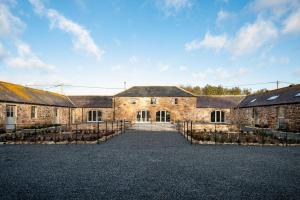 a large brick building with a courtyard in front of it at The Smithy at West Lyham in Chatton