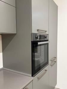 a kitchen with a stainless steel oven and cabinets at appartamento inutile, ma non troppo! in Castelnovo neʼ Monti