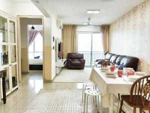 a living room with a table and a couch at AZ 3Rooms Apartment at De Centrum Bangi-Putrajaya in Kajang