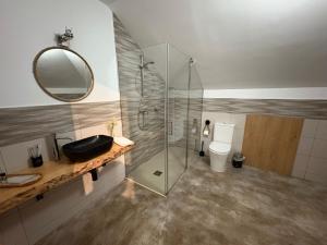 a bathroom with a glass shower and a toilet at Hotel Rural O Salazón in Cambados +91 photos