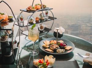 a table topped with plates of food and a drink at InterContinental Hanoi Landmark72 by IHG in Hanoi +173 photos