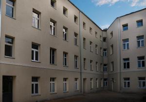 a large building with a lot of windows at Dream Aparts - pokoje blisko dworca Łódź Fabryczna in Łódź