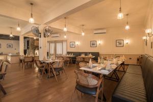 a dining room with tables and chairs and lights at Victoria Mansion - A Signature Collection by HST Hotels in Udaipur