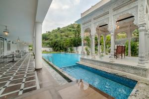 an estate with a swimming pool and a gazebo at Victoria Mansion - A Signature Collection by HST Hotels, Pure Vegetarian in Udaipur