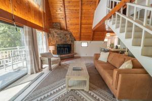 a living room with a couch and a fireplace at Sequoia Vintage A-frame River Retreat in Three Rivers