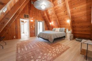 a bedroom with a bed in a wooden cabin at Sequoia Vintage A-frame River Retreat in Three Rivers