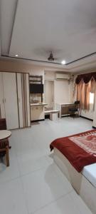 a bedroom with a bed and a living room at Hotel Swaagat in Agra