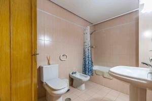 a bathroom with a toilet and a sink at Apartamento Calypso in Las Lagunas Mijas +13 photos