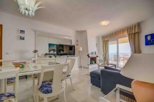 a living room with a blue couch and a table at Apartamento Calypso in Las Lagunas Mijas